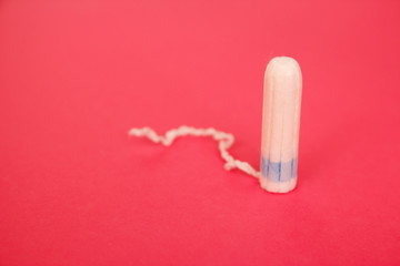 Cotton tampons on pink background. Menstrual period concept. Woman hygiene protection.
