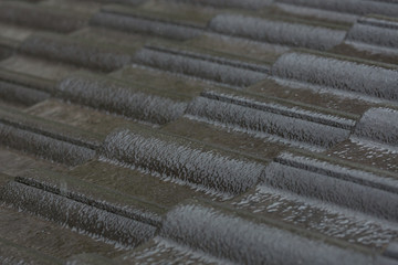 rain storm downpour on black roof tile of residential house