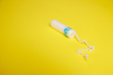 Woman's hygiene and health. White tampon on background. Cotton tampon. Womens comfort, hygiene and protection.