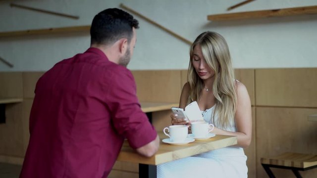 Woman is arguing with man in cafe. Inside