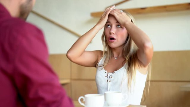 Woman is arguing with man in cafe. Portrait.