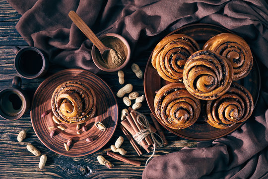 Cinnamon rolls buns with peanuts on a plate