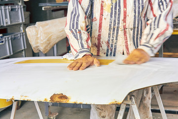 Artist using paint brush for making artificial wood texture.