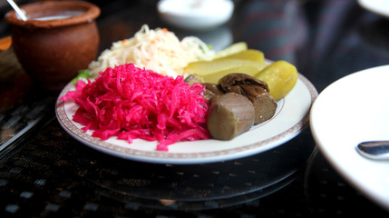 On a plate of assorted pickled vegetables. 