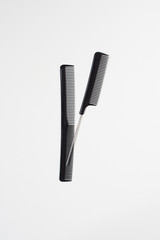 flat lay set of salon hairdressing black combs in order isolated on white background