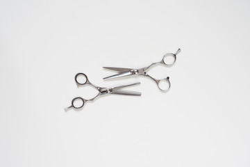 flat lay horisontal open pair of  hairdressing scissors isolated on white background