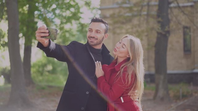 Happy couple takes selfie on the smartphone.