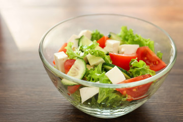 Bowl with fresh vegetable salad on table. Diet food