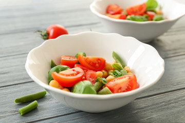 Plate with fresh vegetable salad on table. Diet food