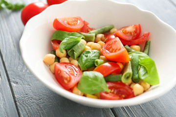 Plate with fresh vegetable salad on table. Diet food