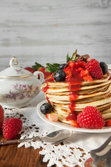 Strawberry chocolate pancakes on a vintage table