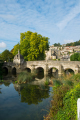 Fototapeta na wymiar The well known ancient bridge over the River Avon with its one-time chapel and later lock-up in autumn sunshine, Bradford on Avon, Wiltshire, UK
