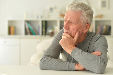 portrait of thoughtful senior man at home