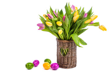 Easter. Easter colored eggs. Flowers Tulips. A bouquet of colorful tulips in a wicker vase. Congratulations on Easter. Isolate on white background