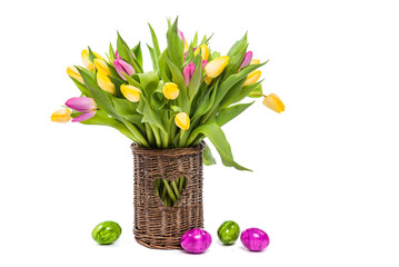 Easter. Easter colored eggs. Flowers Tulips. A bouquet of colorful tulips in a wicker vase. Congratulations on Easter. Isolate on white background
