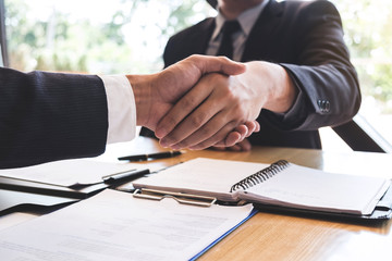 Successful job interview with boss and employee shaking hands after negotiation or interview,...