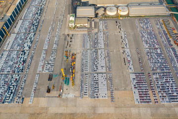 Aerial view. Cars export terminal parked at the dockyard for export and import business. Logistics and transportation