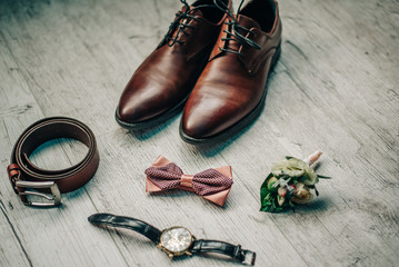 leather shoes, bow tie, leather belt, flower boutonniere, watches