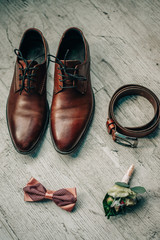 leather shoes, bow tie, leather belt, flower boutonniere