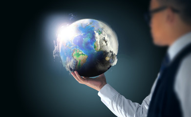 businessman holding the world