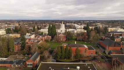 The state capital building adorned with the Oregon Pioneer with downtown Salem in the background