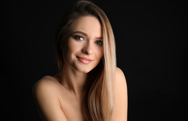 Fototapeta premium Portrait of beautiful young woman on dark background