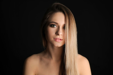 Fototapeta premium Portrait of beautiful young woman on dark background