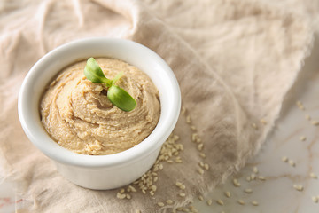 Bowl of tasty tahini on table
