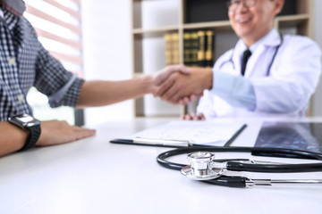 Fototapeta premium Professor Doctor having shaking hands with patient after recommend treatment method while discussing explaining his symptoms or counsel diagnosis health, healthcare and assistance concept