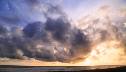 sunset at beach with sky full of cloud
