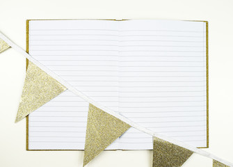 Lined notebook with golden flags copy space
