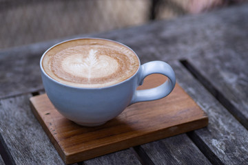 Close-up Of Coffee cup latte art on wooden table.