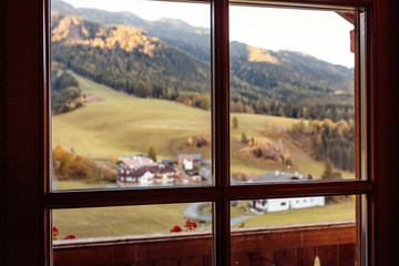 Hotel window with splendid view to autumn Alps