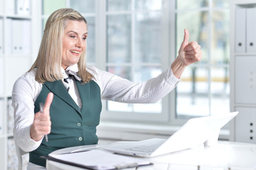 senior woman in formal wear working in office 