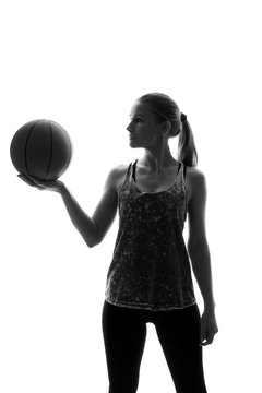 Portrait Of Beautiful Woman Playing Basketball On White Background