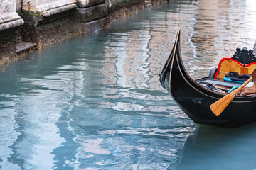 Gondola with tourists travels along the Grand Canal in Venice