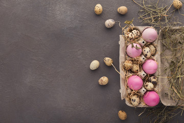 Easter background. Colored eggs on gray stone surface