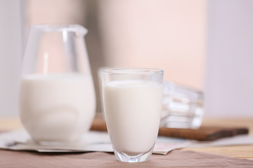Glass of fresh milk on table