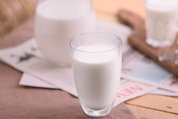 Glass of fresh milk on table