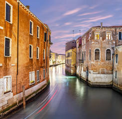 Fototapeta na wymiar Narrow canal street at Early evening blue hour in Venice, Italy