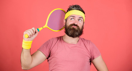 Tennis sport. Tennis club concept. Man bearded hipster wear old school sport outfit with bandages. Tennis can be an effective way to lose weight. Athlete hold tennis racket in hand on red background