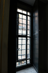 Vintage window with iron lattice in dark background