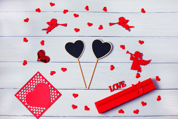 Valentines Day. Frame made of gifts, postcard, confetti, heart, angels on wooden background. Valentines day background.