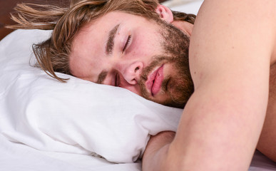 Man handsome guy lay in bed. Get adequate and consistent amount of sleep every night. Expert tips on sleeping better. Bearded man sleeping face relaxing on pillow. How much sleep you actually need