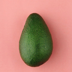 Fresh organic avocado isolated. Color of year 2019 Living Coral concept. Coral background with avocado.