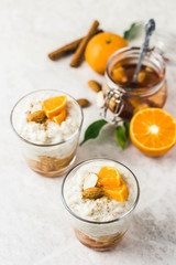 Overnight oatmeal pudding with tangerines. Top view, space for text.