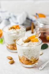 Healthy vanilla  oatmeal porridge with fresh fruit and nuts. Selective focus, space for text.