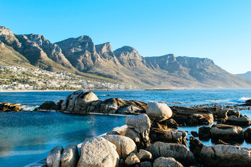 Scenic, serene landscape of the natural, dark blue tide pools of Maiden's Cove near Camps Bay in...