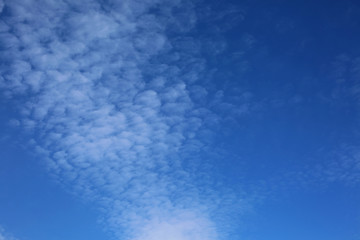 Blue sky background with clouds and copy space.