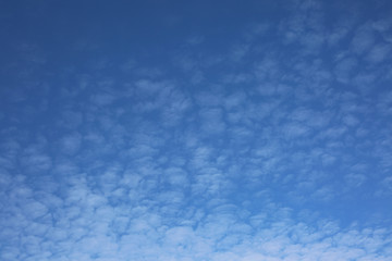 Blue sky background with clouds and copy space.